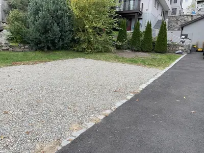 a driveway in front of a house with a yard at California guest house in Greenwich