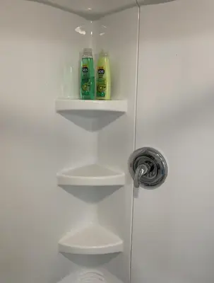 a white cabinet with three bottles of detergent at California guest house in Greenwich