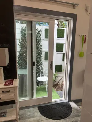 a sliding glass door with a chair outside at California guest house in Greenwich