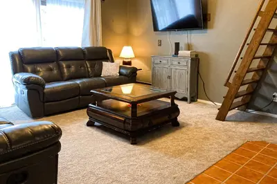 a living room with a leather couch and a coffee table at Glorious Scenery in Dover