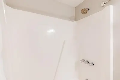 a bathroom with white walls and chrome fixtures at Glorious Scenery in Dover