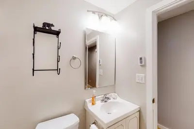 a white bathroom with a sink and a mirror at Glorious Scenery in Dover