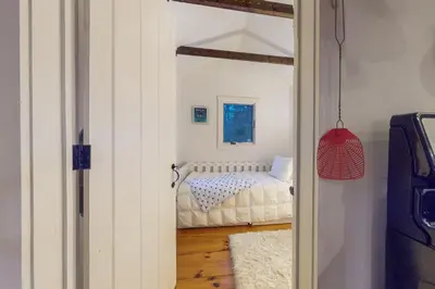a small bedroom with a bed in a room at Little Red in Wilmington