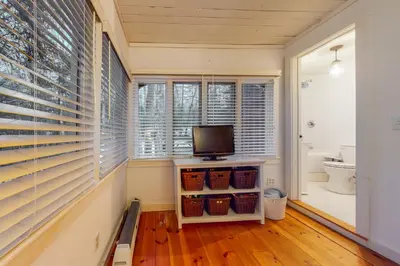 a room with blinds on the windows and a television at Little Red in Wilmington