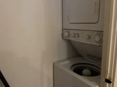 a washer and dryer in a corner of a room at Little Red in Wilmington