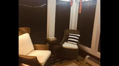 a living room with two chairs and a window at Little Red in Wilmington