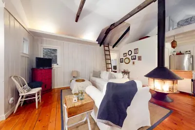 a living room with a white couch and a fireplace at Little Red in Wilmington
