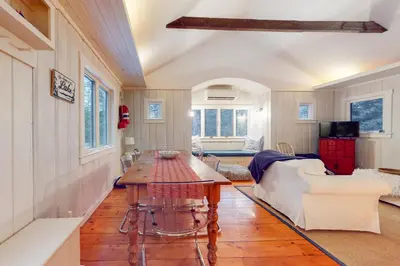 a living room with a table and a couch at Little Red in Wilmington