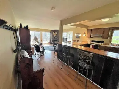 a kitchen with a bar with stools in it at Close to skiing and hiking, walk to main street in Tannersville