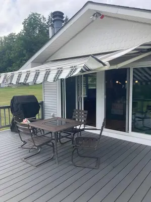 a wooden deck with a table and chairs on a house at Close to skiing and hiking, walk to main street in Tannersville
