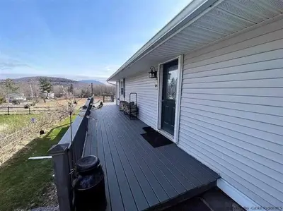 a wooden deck on the side of a house at Close to skiing and hiking, walk to main street in Tannersville