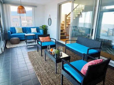 a patio with chairs and tables and a couch at Casa al Mare Beachfront Retreat King Bed Near Yale in East Haven