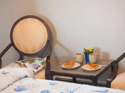a small table with two plates of food on it at Casa al Mare Beachfront Retreat King Bed Near Yale in East Haven