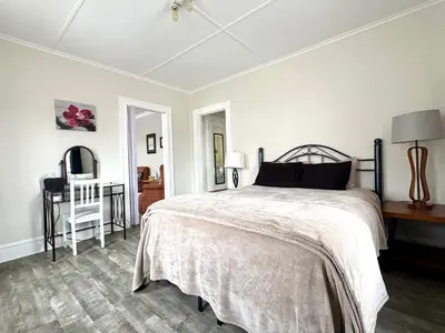 a bedroom with a bed and a table and a chair at The Elizabeth Suite B2 in Hartford