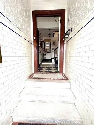 a stairway leading into a hallway with a doorway at The Elizabeth Suite B2 in Hartford