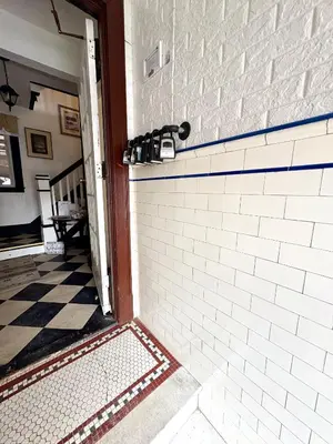 aoyer with a white brick wall and a tile floor at The Elizabeth Suite B2 in Hartford