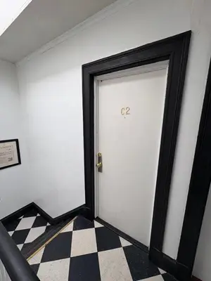 a door in a room with a checkered floor at The Bushnell Suite C2 in Hartford
