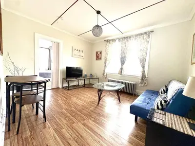 a living room with a blue couch and a table at The Bushnell Suite C2 in Hartford