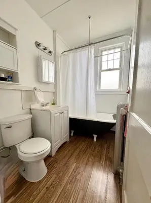 a bathroom with a toilet and a bath tub at The Bushnell Suite C2 in Hartford
