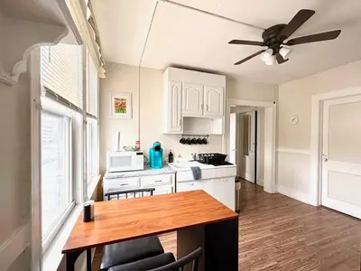 a kitchen with a table and a ceiling fan at The Bushnell Suite C2 in Hartford