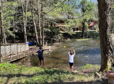 a man and a woman standing in a river at Peaceful Gateway to Island Creek Cottage in East Stroudsburg