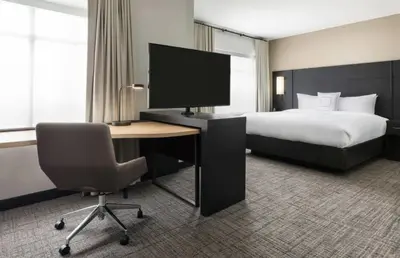 a hotel room with a bed and a desk with a computer at Residence Inn by Marriott New Haven Hamden in Hamden