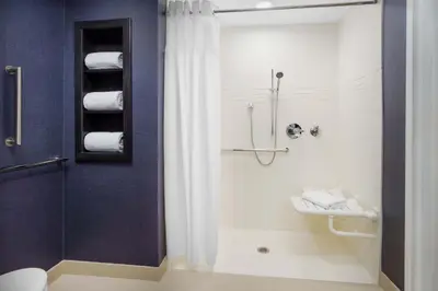 a bathroom with a shower with a toilet and a sink at Residence Inn by Marriott New Haven Hamden in Hamden