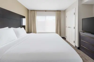 a bedroom with a large white bed and a television at Residence Inn by Marriott New Haven Hamden in Hamden