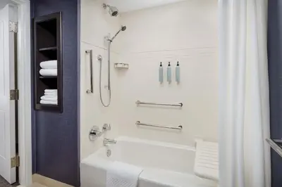a bathroom with a white tub and a shower at Residence Inn by Marriott New Haven Hamden in Hamden