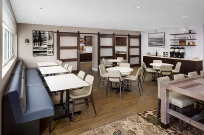 a restaurant with tables and chairs and a counter at Residence Inn by Marriott New Haven Hamden in Hamden