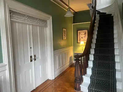 a hallway with a spiral staircase and a door at 1 Br Private Victorian Apt in convenient City location on half acre sleeps 4 in Poughkeepsie