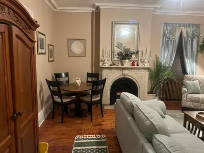 a living room with a couch and a table at 1 Br Private Victorian Apt in convenient City location on half acre sleeps 4 in Poughkeepsie
