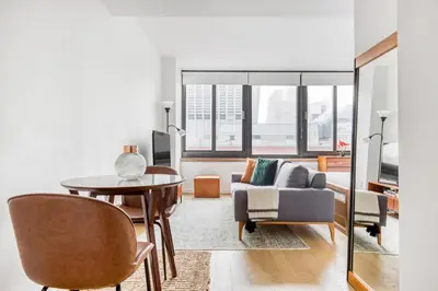 a living room with a table and a couch at Tribeca Studio Indoor pool Great views NYC-185 in New York