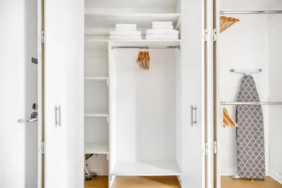 a closet with white shelves and a tie in it at Tribeca Studio Indoor pool Great views NYC-185 in New York