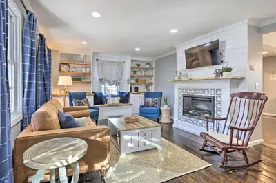 a living room with a couch and a fireplace at Bright Cornwall-On-Hudson Vacation Rental! in Cornwall-on-Hudson