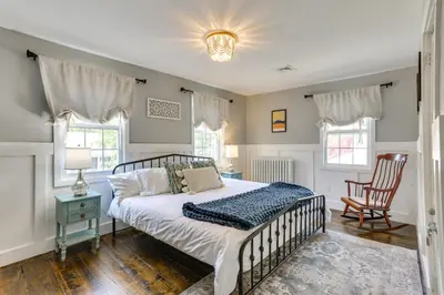 a bedroom with a bed and two chairs at Bright Cornwall-On-Hudson Vacation Rental! in Cornwall-on-Hudson