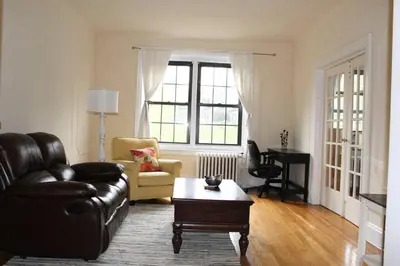 a living room with a leather couch and a coffee table at Fantastic stay for 4 – Heart of Hoboken! in Hoboken