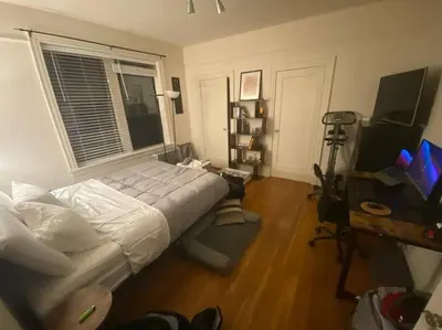 a bedroom with a bed and a desk and a window at Comfy stay – sleeps 4 (Hoboken) in Hoboken
