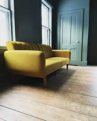 a yellow couch sitting in a living room at The Brookside Lodge & Cottage in Dover