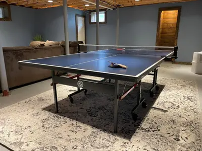 a ping pong table in a living room at Bear House Catskills - Private Pool, Pond, Hot Tub, Work-Friendly in Cairo