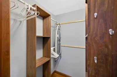 a walk in closet with wooden shelving in a room at Poconos Peaceful Retreat - Families & Large Groups in Tobyhanna