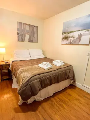 a bedroom with a bed with two towels on it at 1st Base Apt 1 All Star Baseball Rentals in Oneonta