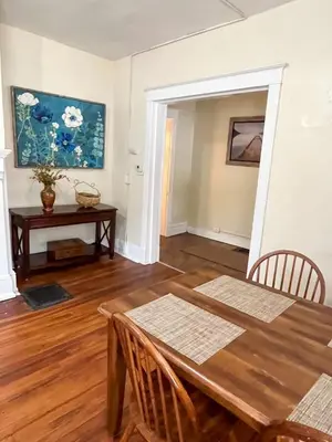 a dining room with a wooden table and a desk at 1st Base Apt 1 All Star Baseball Rentals in Oneonta