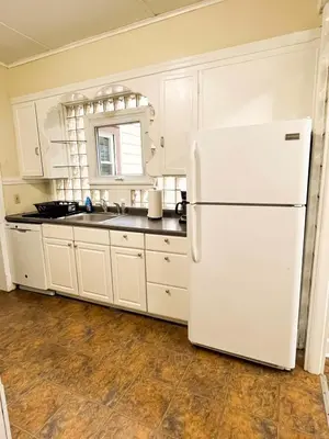 a kitchen with white cabinets and a white refrigerator at 1st Base Apt 1 All Star Baseball Rentals in Oneonta