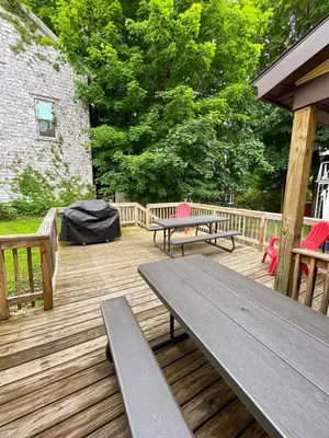a wooden deck with two benches and a picnic table at 1st Base Apt 1 All Star Baseball Rentals in Oneonta