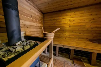 an inside of a sauna with a wood wall at Log Home w Mountain Views Near Windham & Hunter Ski Resorts in Maplecrest