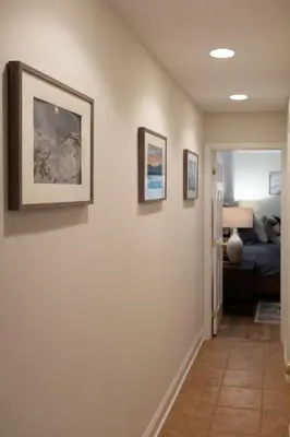 a hallway with paintings on the walls of a bedroom at NEWLY REMODELED FOUR BEDROOM All SEASON CONDO W MOUNTAIN VIEWS in East Jewett