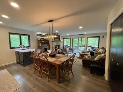 a kitchen and living room with a table and chairs at Mountain Condo with Modern Cabin Style in East Jewett