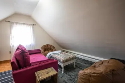 a living room with a purple couch and a chair at Cozy Tiny Haus Apt in Torrington