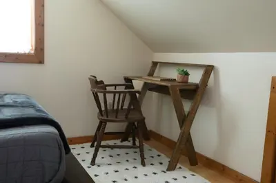 a desk in the corner of a room with a chair at Cozy Tiny Haus Apt in Torrington
